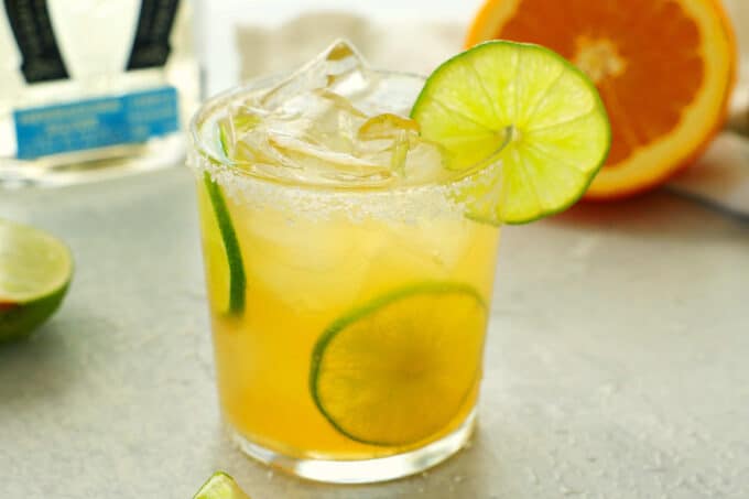 A skinny margarita with citrus and tequila in the background