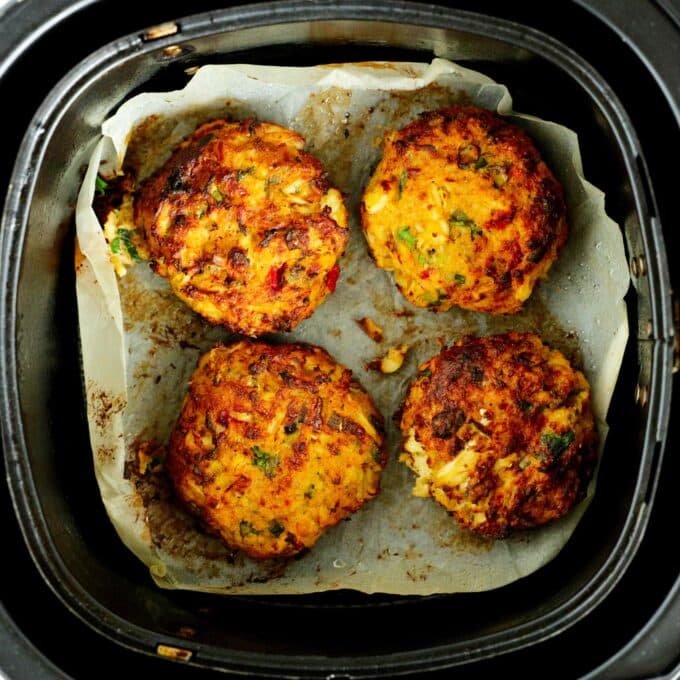 An overhead look at cooked crab cakes in an air fryer
