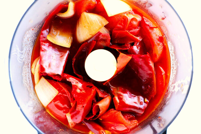 Tomatoes, peppers, onions, and garlic added to a food processor