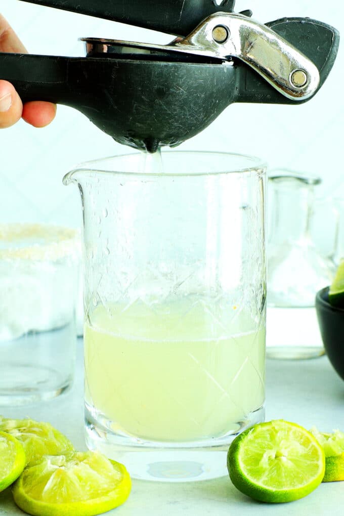 a lime being juiced with a hand juicer
