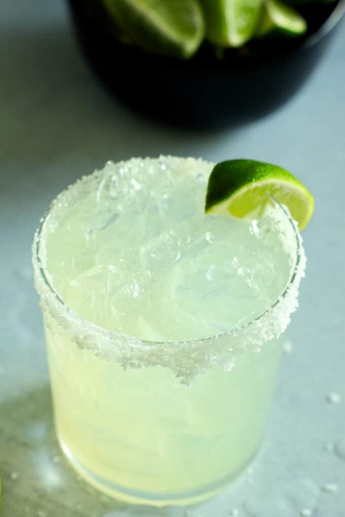 a margarita with a salt rim and a lime wedge