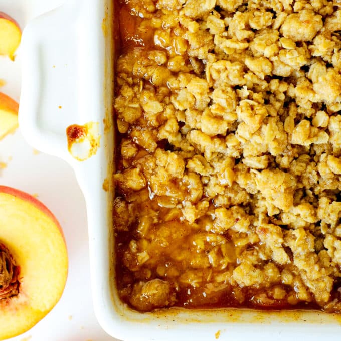 overhead view of peach crisp in a baking dish