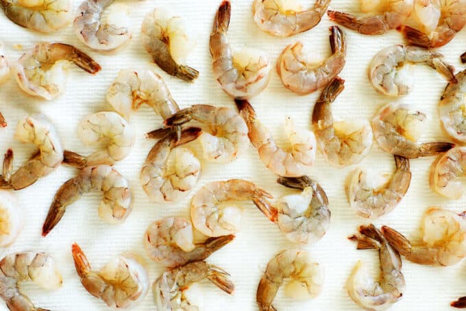 raw Shrimp with tails laying on paper towels