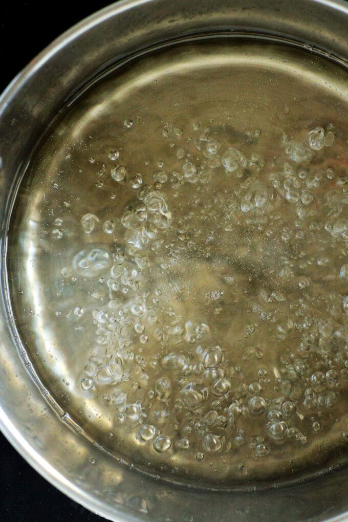 overhead view of simple syrup boiling in a sauce pan