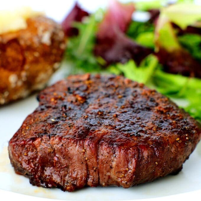 a top sirloin with potatoes and salad in the background