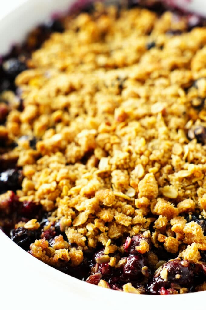 A close-up of cooked blueberry crisp still in the pan