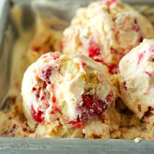 three scoops of ice cream with strawberry sauce and graham cracker throughout