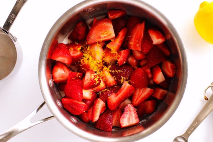 strawberry slices and lemon zest in a saucepan