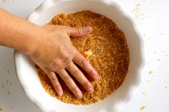 an overhead view of the wafer crust being packed down by hand