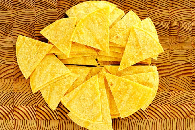 a pile of corn tortillas cut into triangles