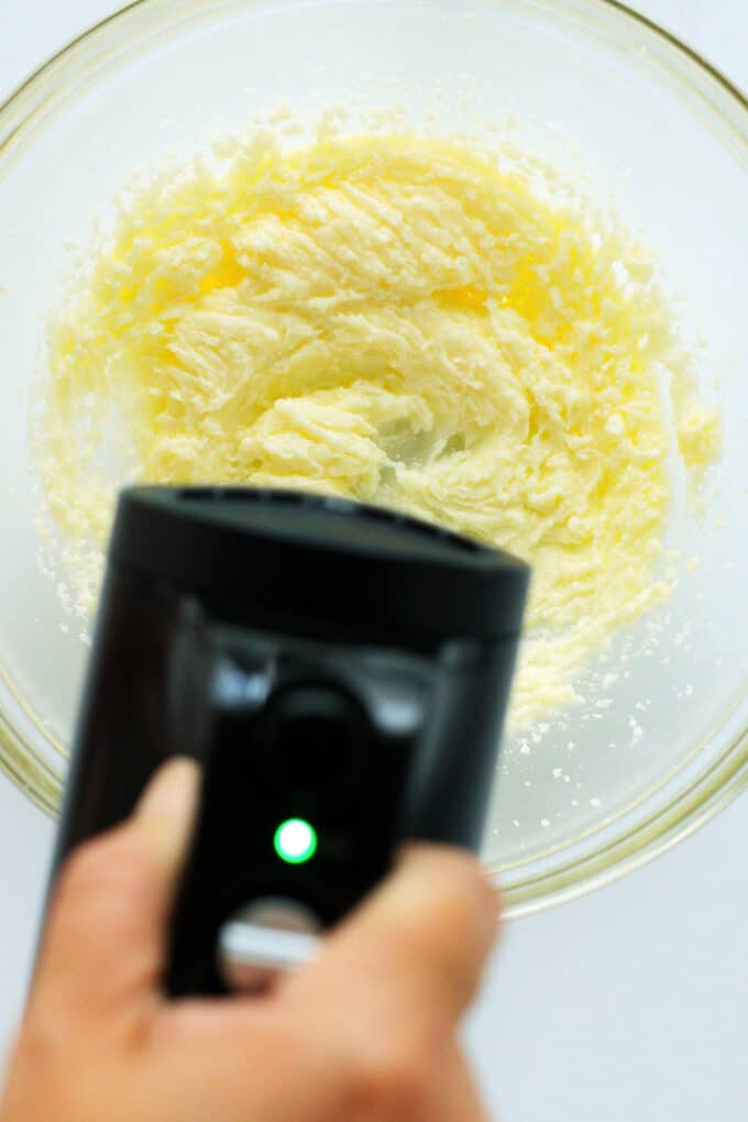 a hand mixer being used to cream wet ingredients
