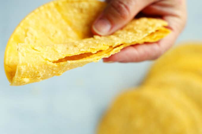 a demonstration of a corn tortilla cracking when folded