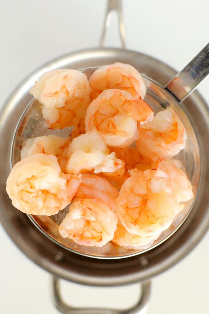 jumbo, cooked shrimp in a strainer