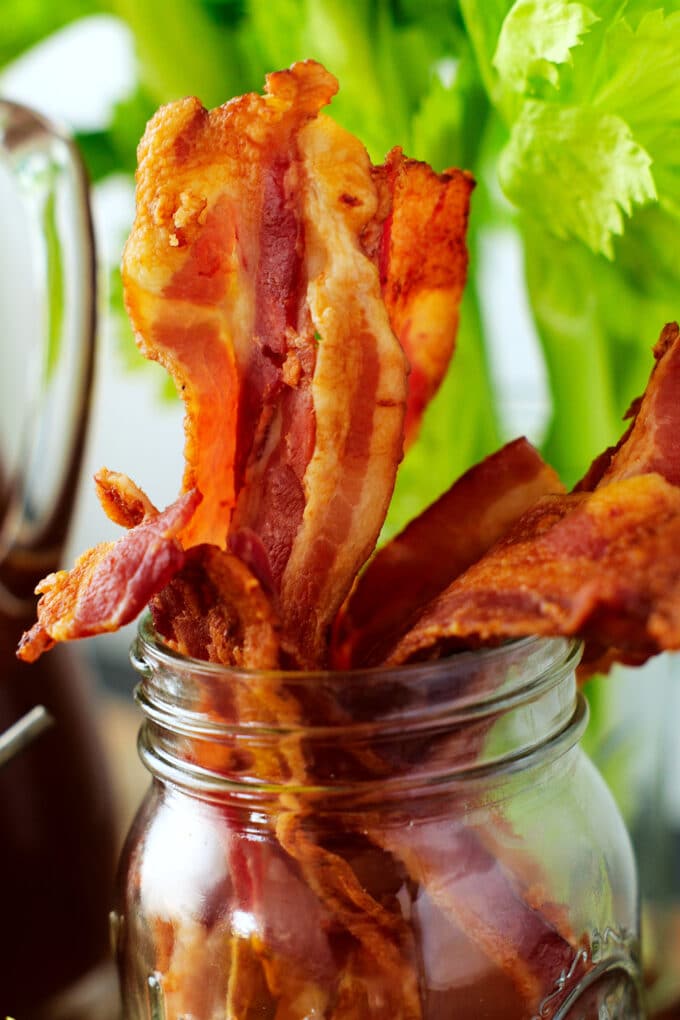 crispy bacon standing in a glass jar