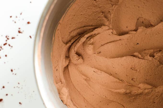 an overhead look at finished chocolate whipped cream in a big metal bowl
