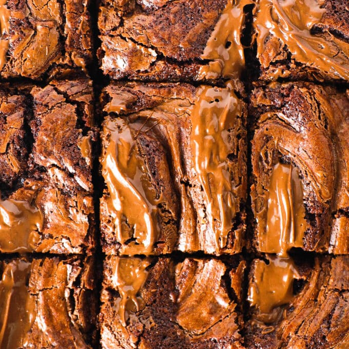 An overhead view of the cooked brownies, sliced. the tops are crusty and the Nutella swirl is visible