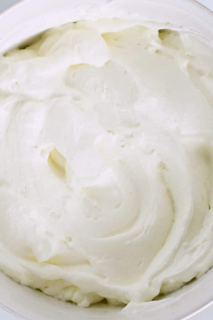 a close up of the fluffy whipped cream in a bowl