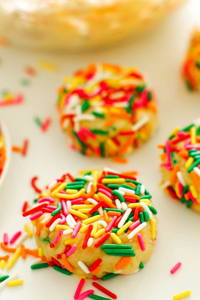 a close up of the Funfetti Cookies before baking, covered in colorful sprinkles
