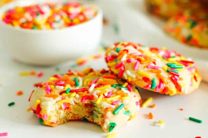on Funfetti cookie propped up against another with a bite taken out of it
