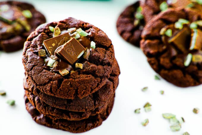 A stack of Andes Mint Cookies in the foreground with others sitting around in the background.