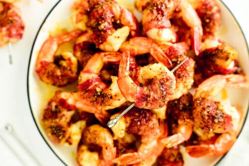 An overhead look at a heaping plate of Bacon Wrapped Shrimp.