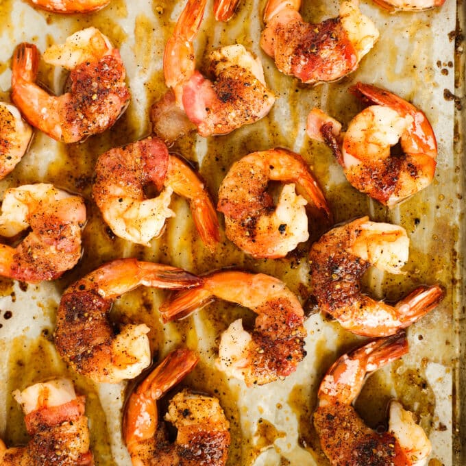 An overhead view of cooked Bacon Wrapped Shrimp, still on the baking sheet.