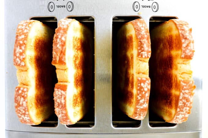 An overhead view of four slices of toast in the toaster.