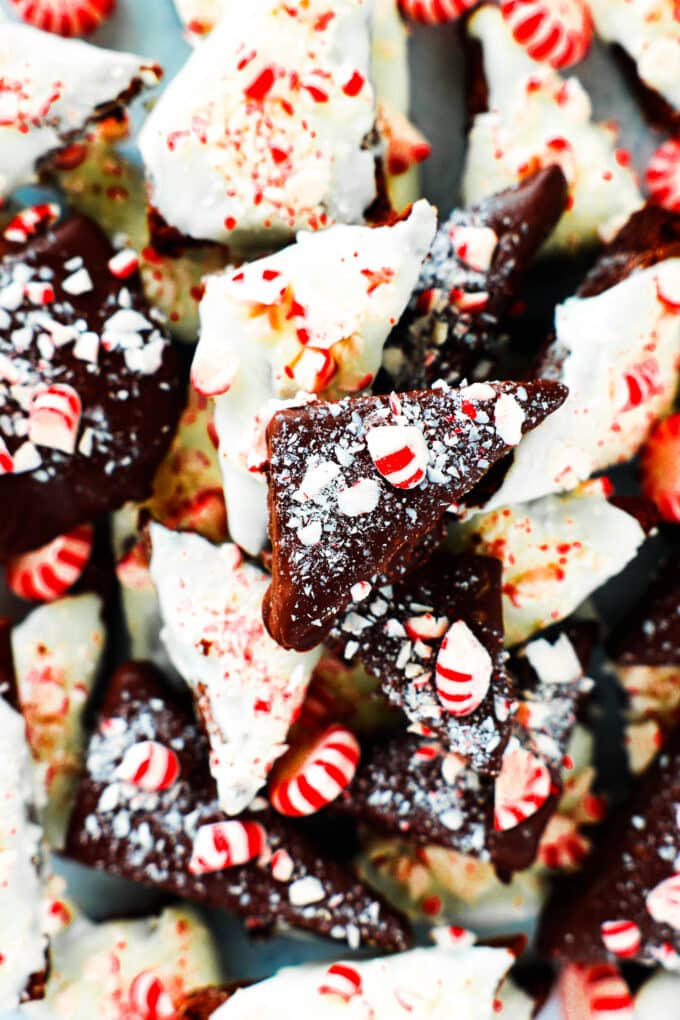 An overhead view of white and dark Peppermint Bark Brownies in a pile with crushed peppermint candies on top.