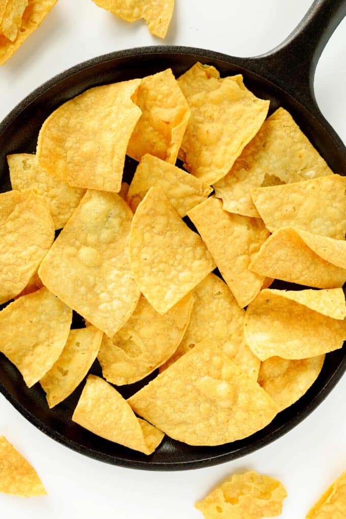 An overhead view of an iron pan with a layer of corn chips in the bottom.