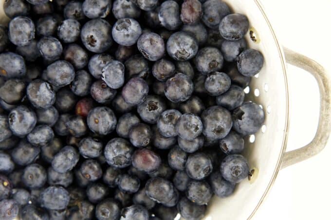 A colander full of fresh blueberries.
