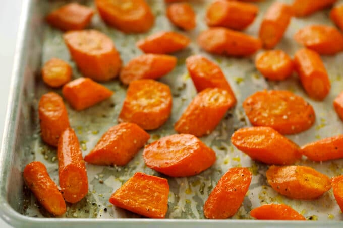 Roasted Carrots fresh out of the oven, on a parchment-lined baking sheet.