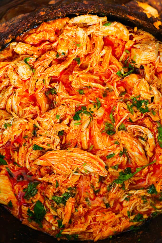Crockpot Buffalo Chicken once it's been shredded up, added back to the crockpot, and mixed with the sauce.