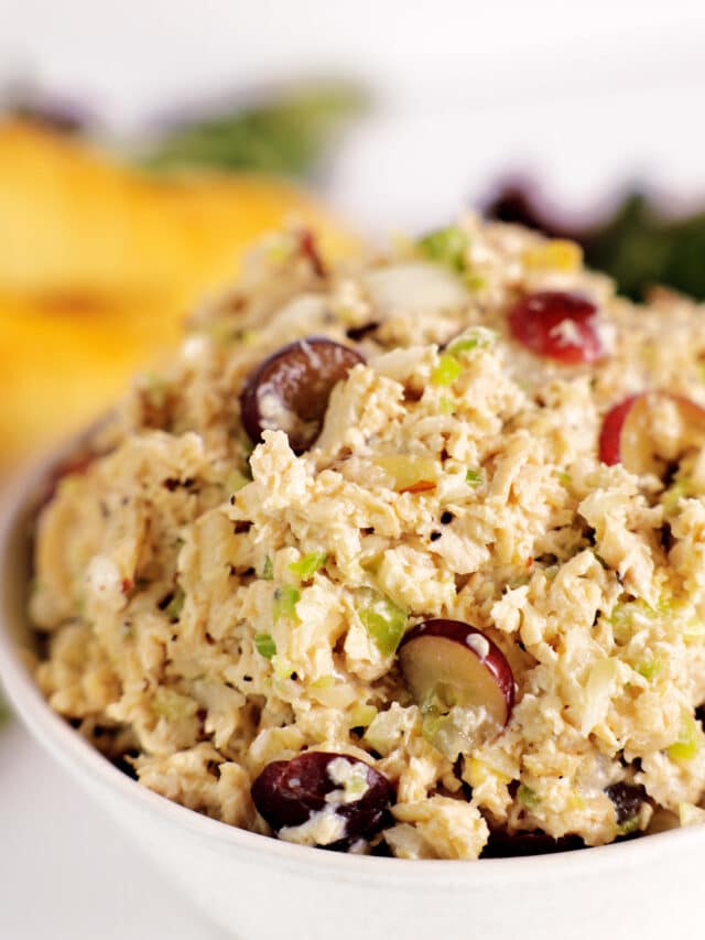 A white bowl heaping full of Chicken Salad with Grapes.