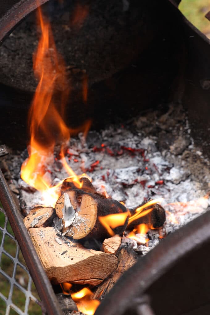 A wood fire going inside a smoker.