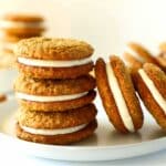 A stack or three Oatmeal Cream pies with two other leaning against the stack. They are all on a white plate.