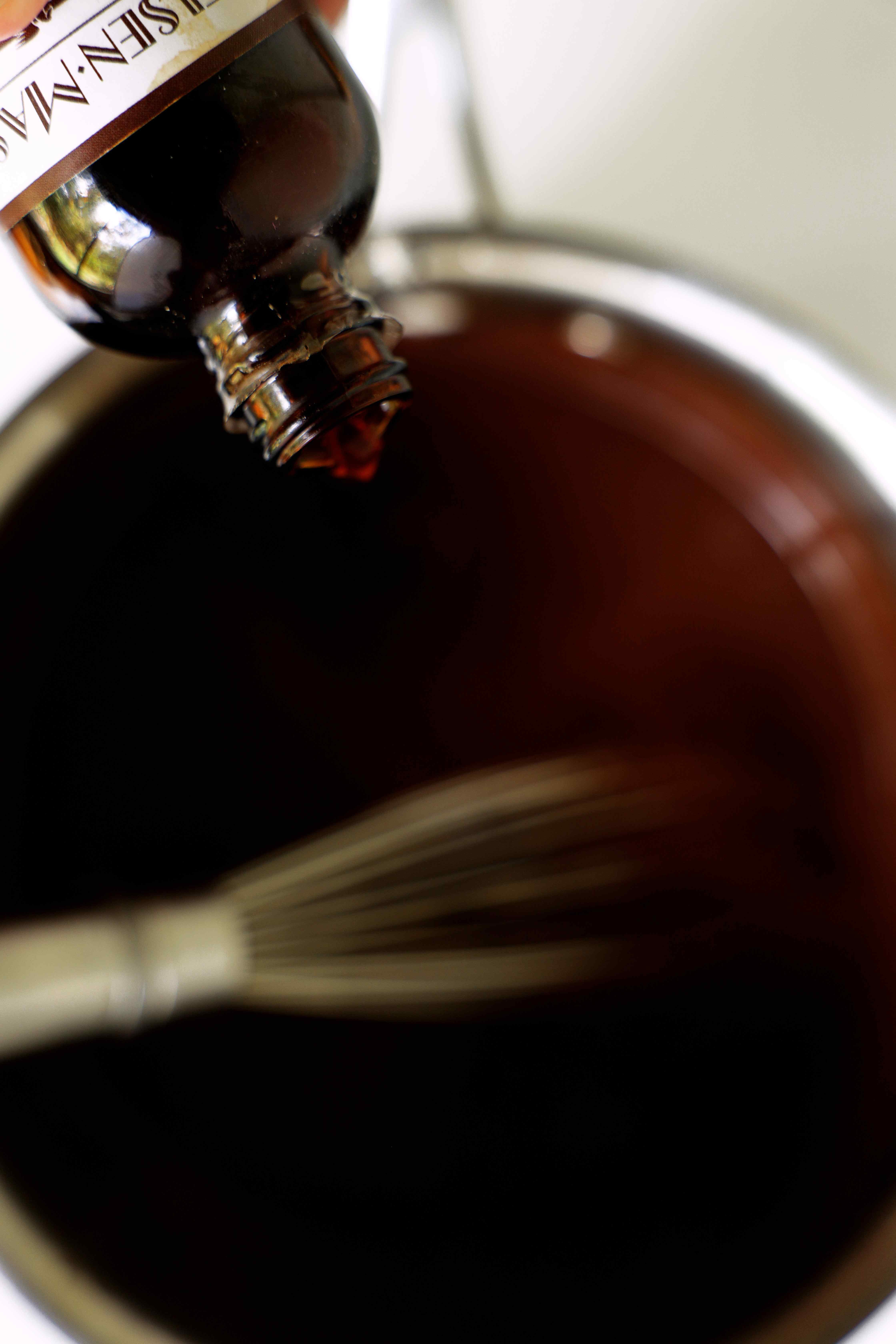 Vanilla extract being poured into the Chocolate Gravy mixture