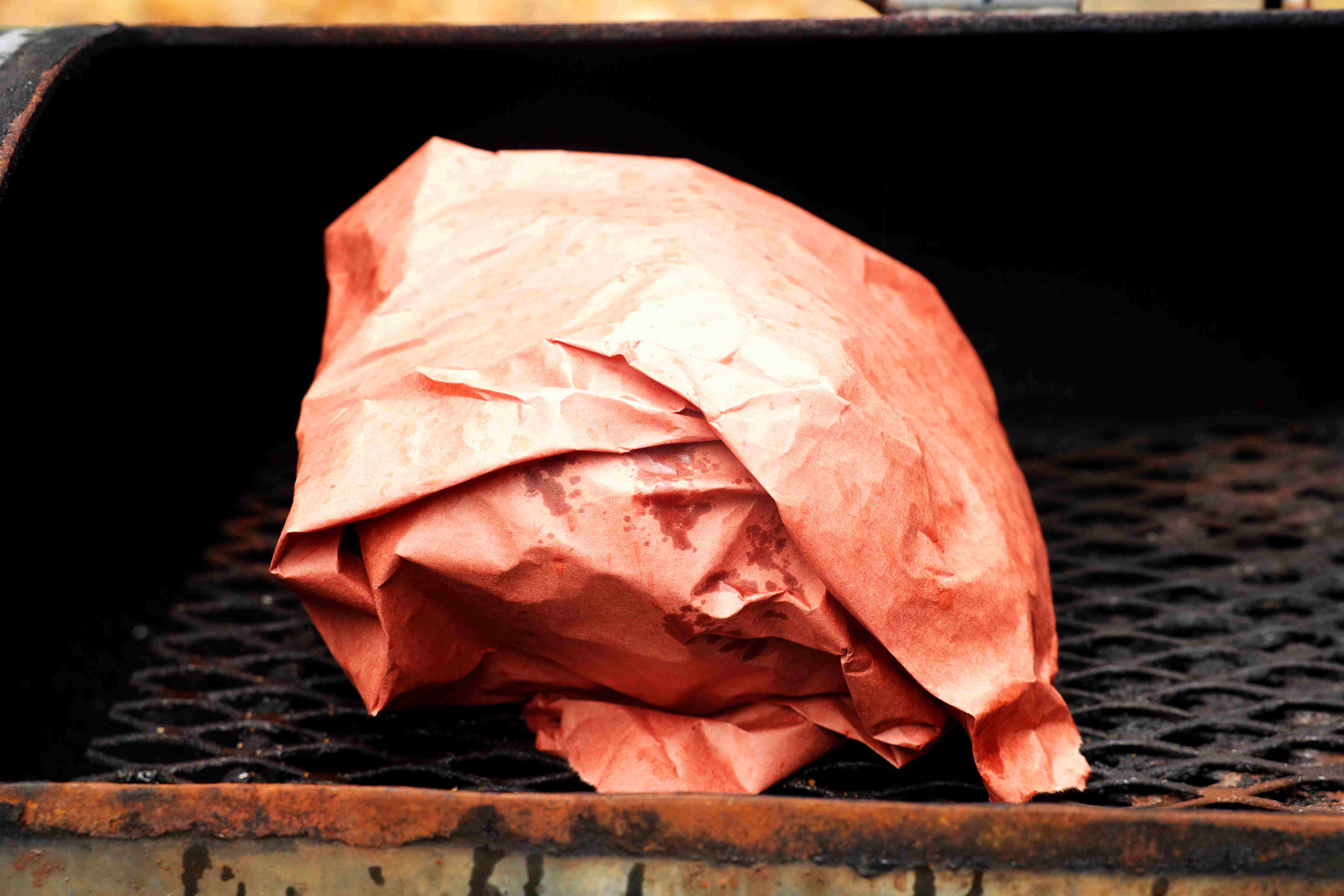 Smoked Turkey Breast wrapped in butcher paper on a smoker