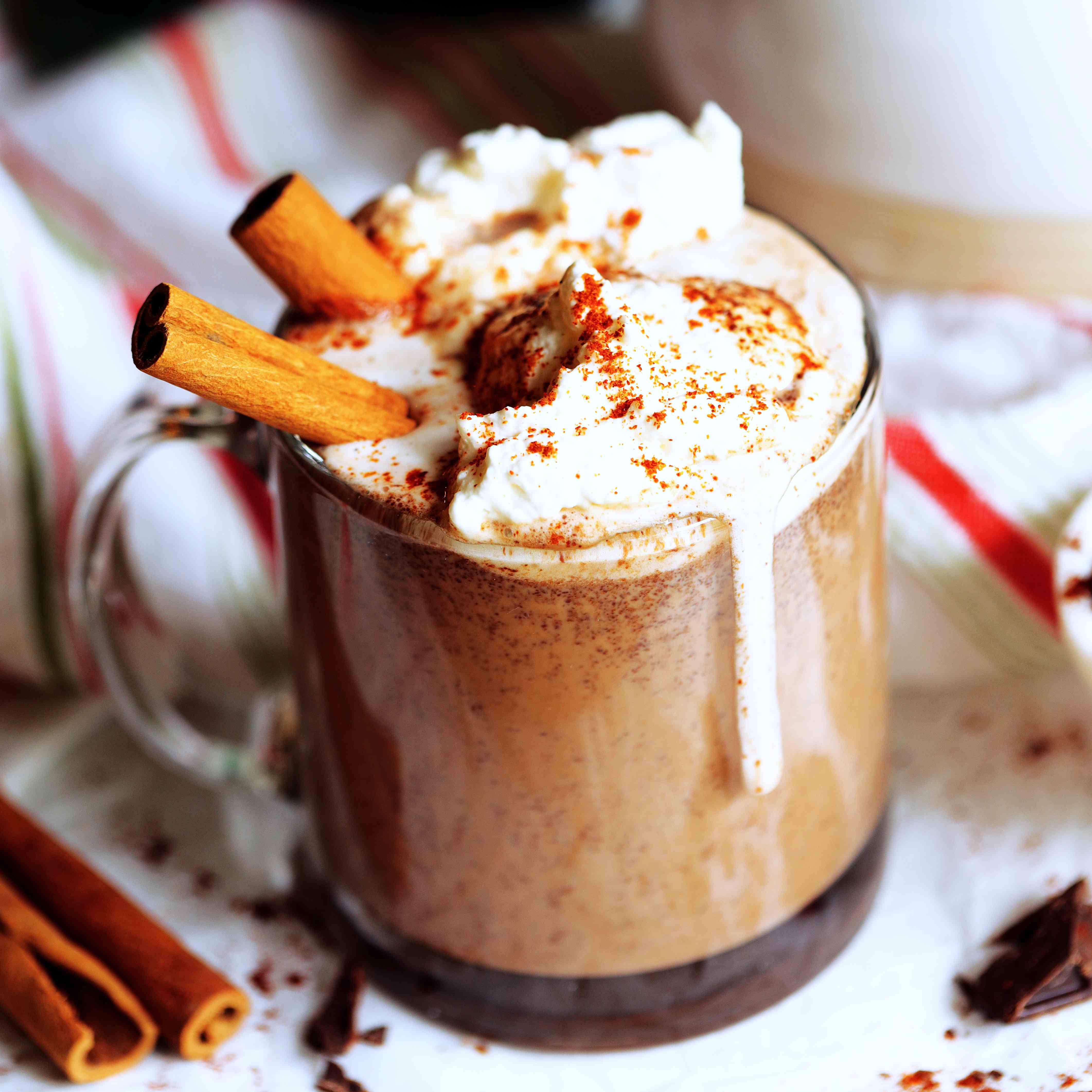 Mexican Hot Chocolate topped with whipped cream and cinnamon sticks