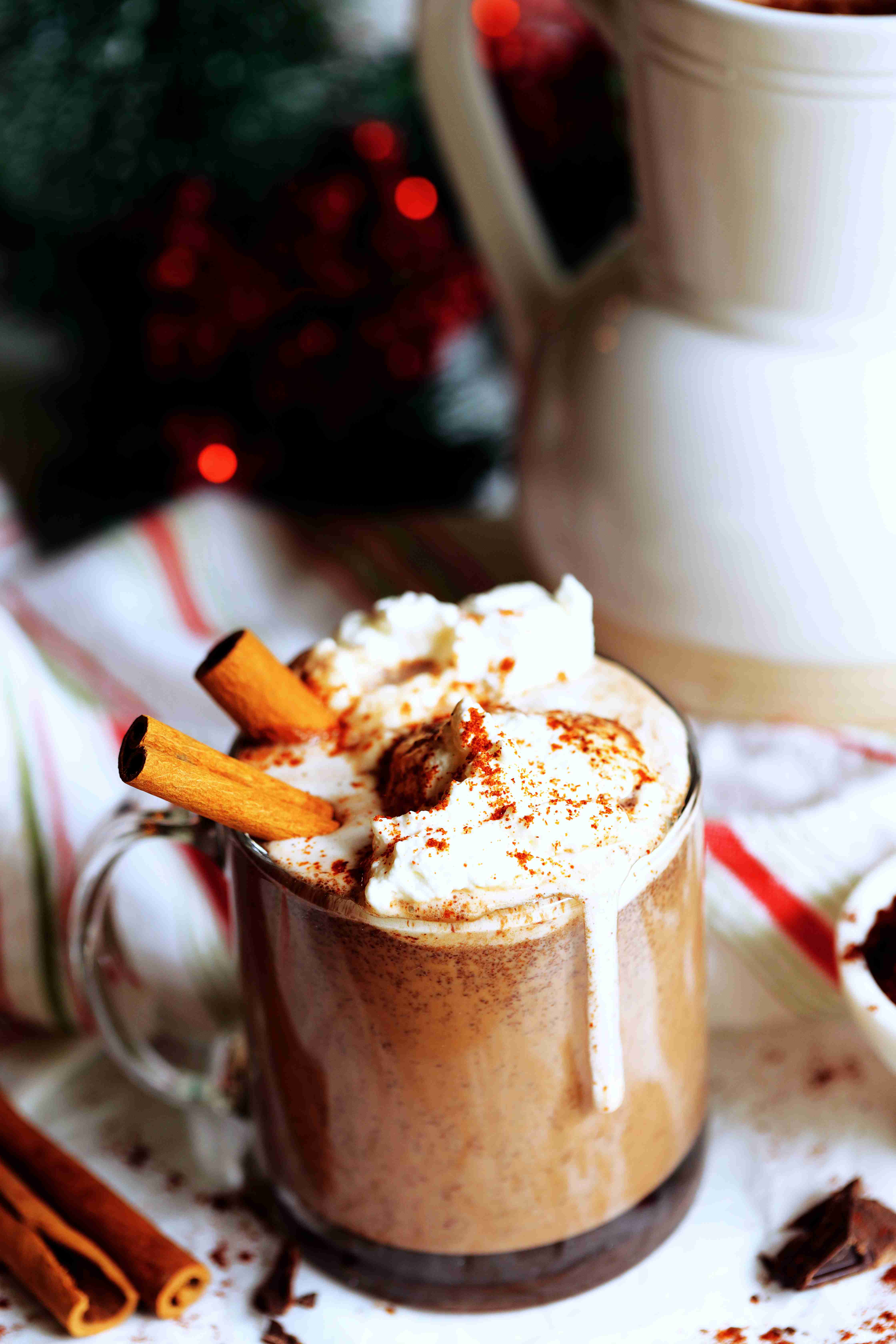 Mexican Hot Chocolate topped with whipped cream and cinnamon sticks