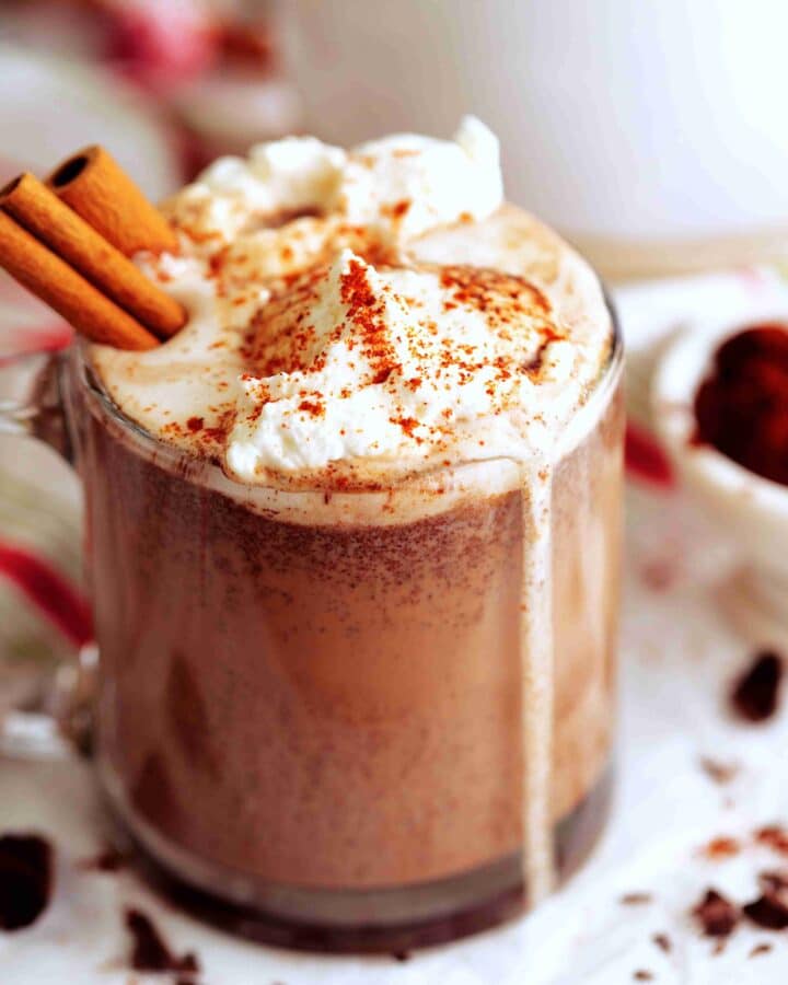 Mexican Hot Chocolate topped with whipped cream and cinnamon sticks