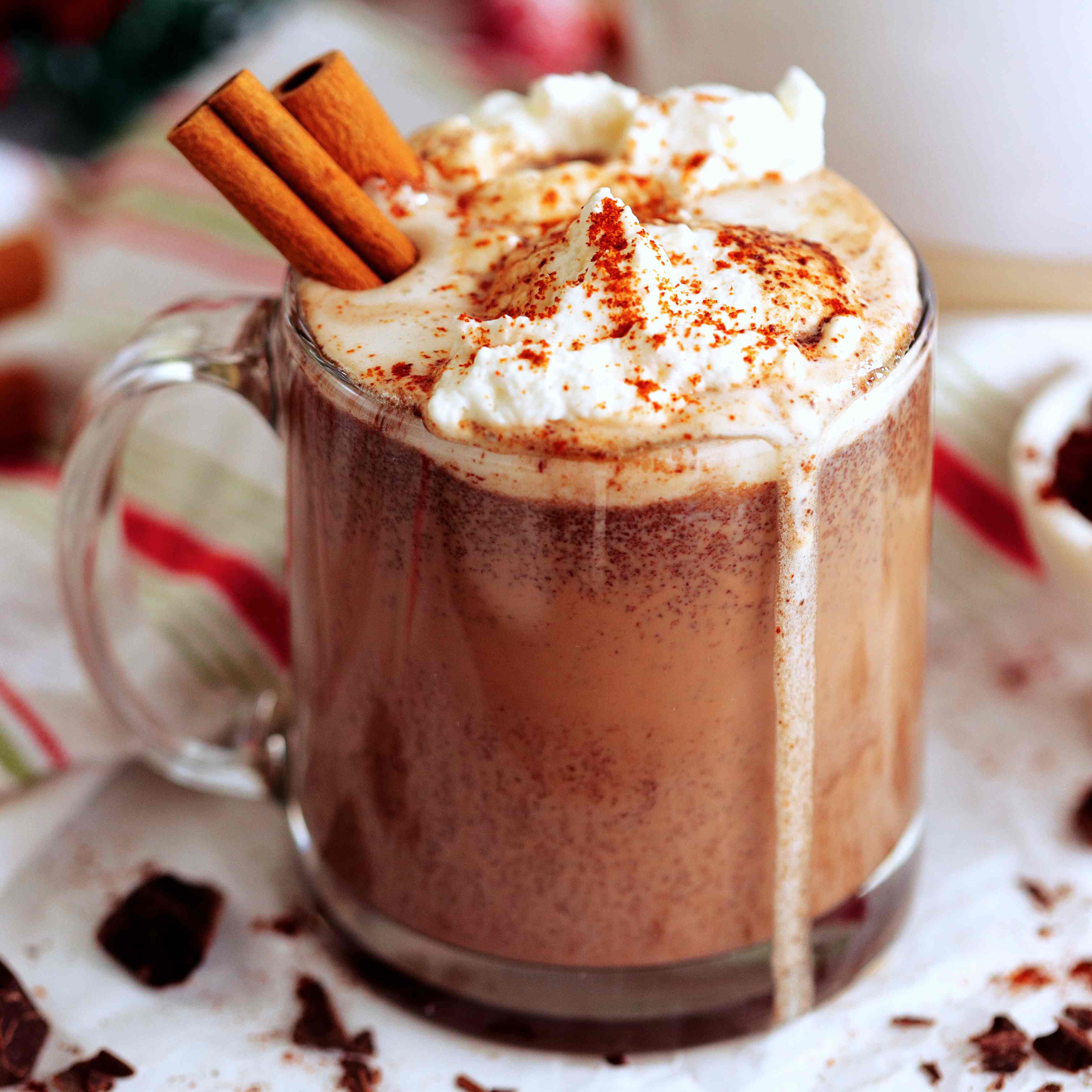 Mexican Hot Chocolate topped with whipped cream and cinnamon sticks