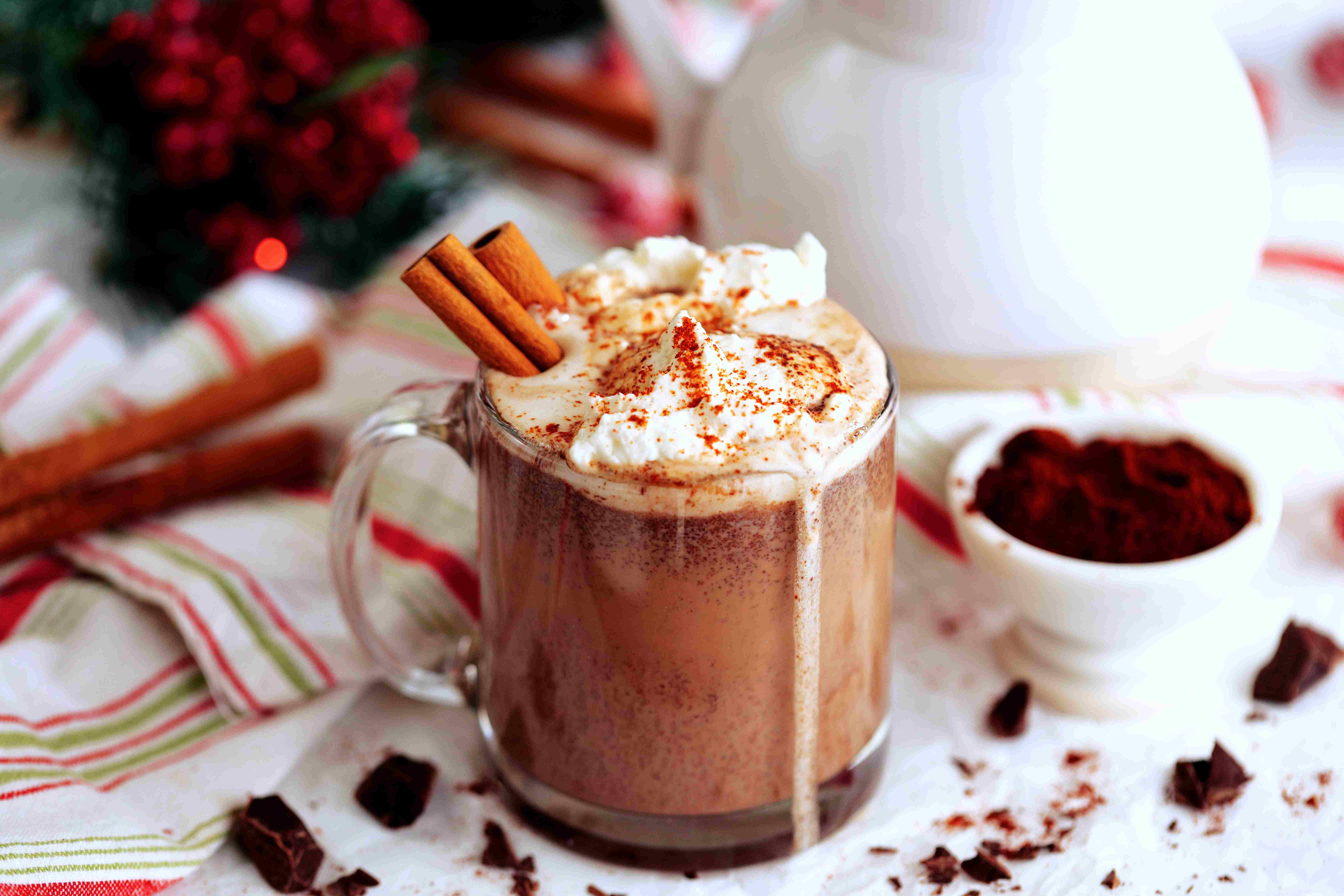 Mexican Hot Chocolate topped with whipped cream and cinnamon sticks