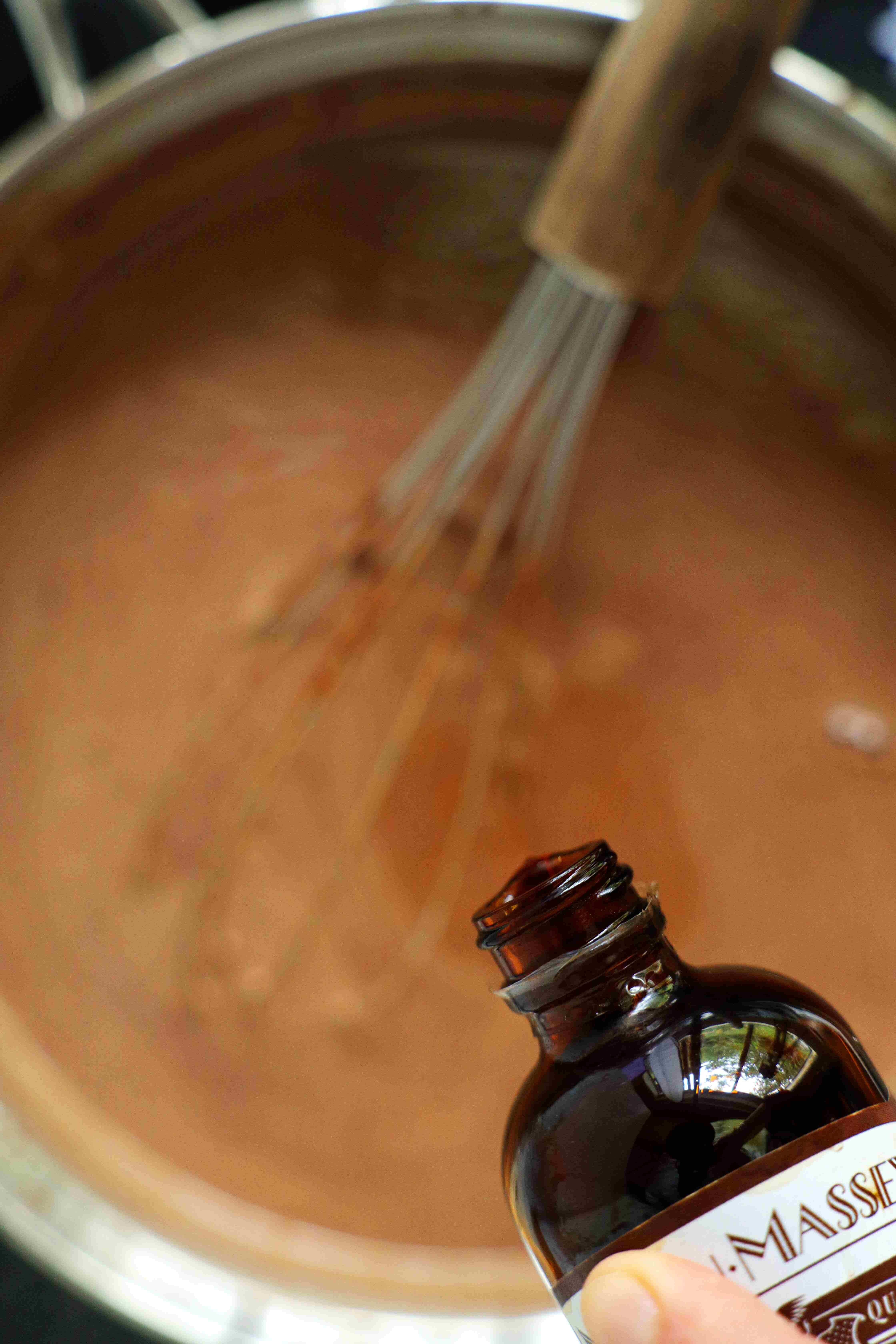 Vanilla being added to mixing bowl of wet Mexican Hot Chocolate mix