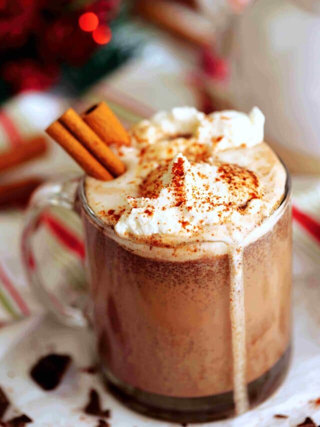 Mexican Hot Chocolate topped with whipped cream and cinnamon sticks