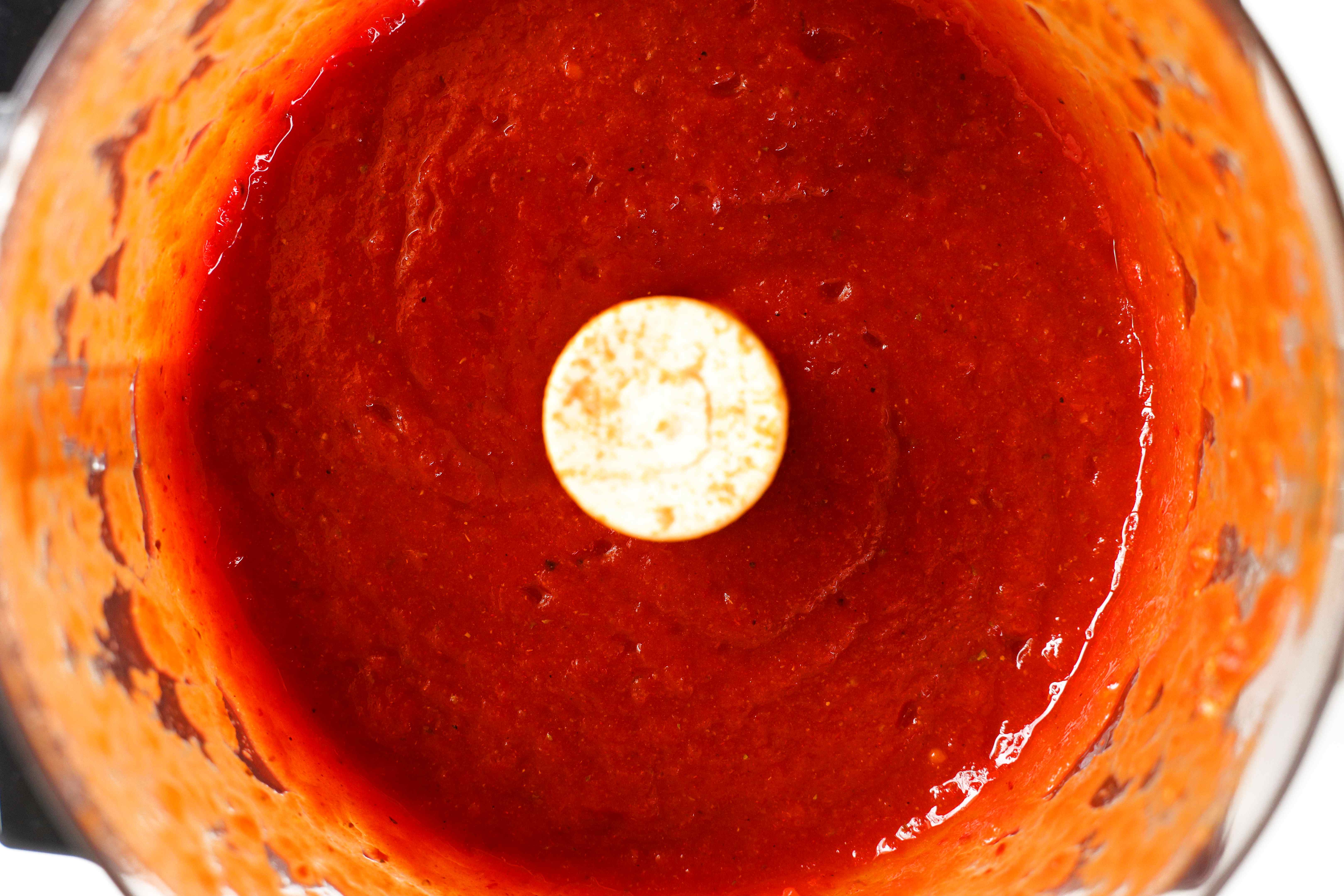 Overhead shot of blended ingredients of Tinga de Pollo sauce in a food processor