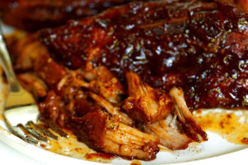 Country-Style Pork Ribs with sauce on a white plate.