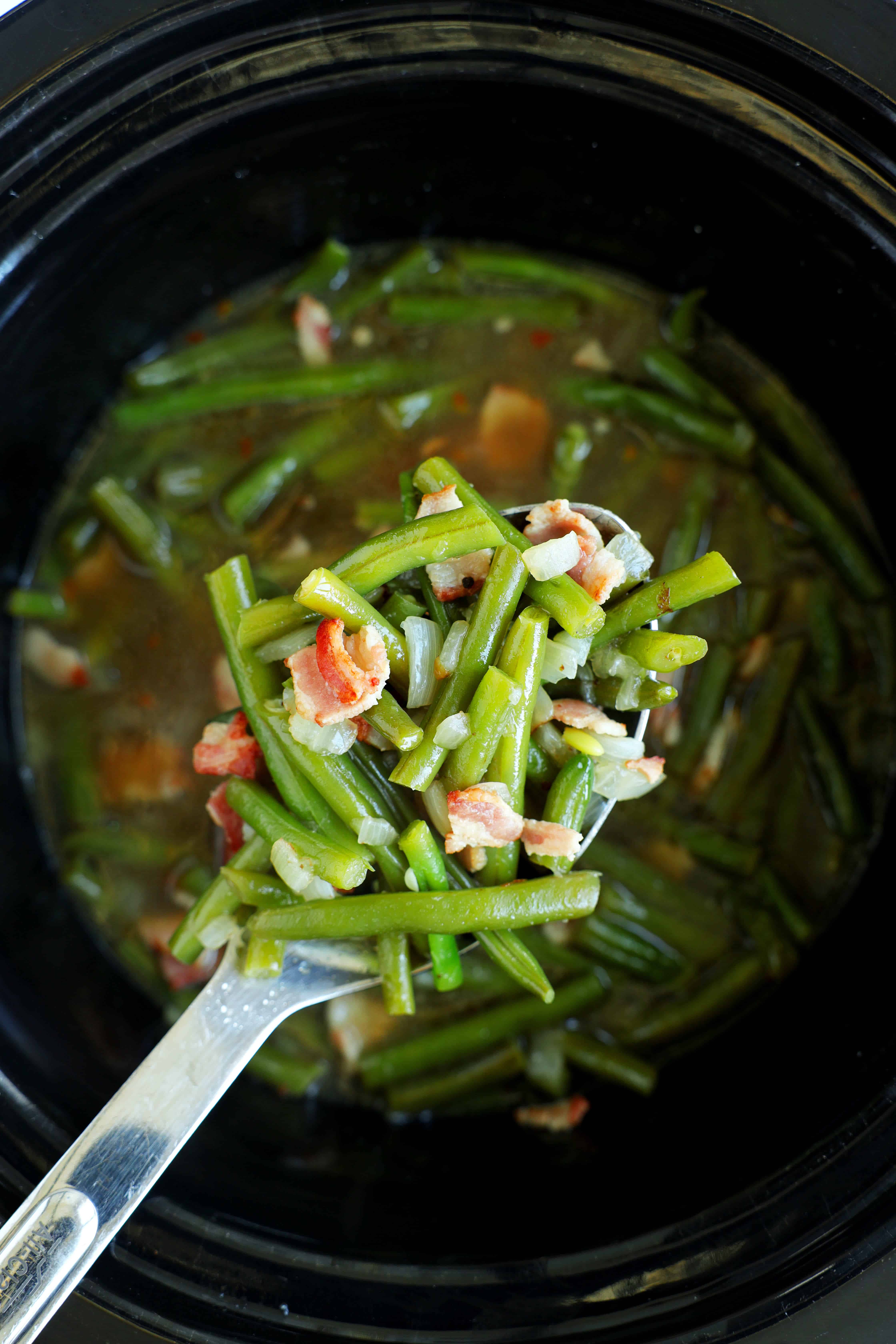 Fresh green beans cooked with bacon and onion in a slow cooker