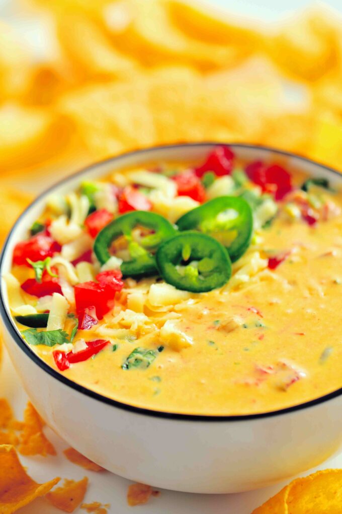 Velveeta dip topped with shredded cheese, sliced jalapenos, and pico