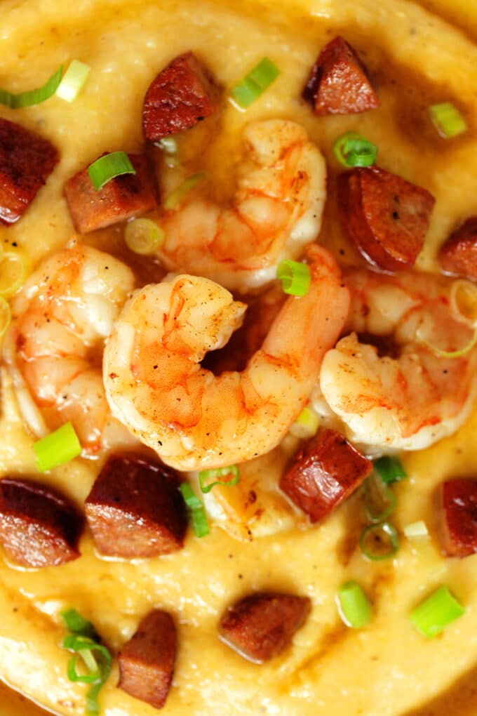 An overhead shot of a bowl of shrimp and grits in a bowl.