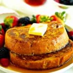 Sourdough French toast with fresh berries, maple syrup, and butter
